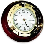 SOLID BRASS PORTHOLE CLOCK ON MAHOGANY