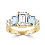 Classic Wide Ring with a 2 Ct. Emerald Cut Brilliant Masterpiece in the center, saluted on each side by a 0.5 ct. Emerald Cut Aquamarine Stone and clear white Baguette Masterpieces further down. 3.5 Cts. T.W, in 14K Solid Gold.