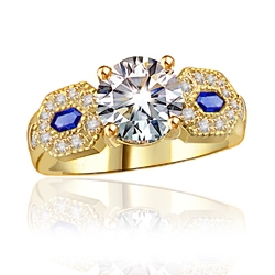 Impressive ring, its 2.0 ct. round cut Diamond Essence diamond set off by lozenge-shaped Sapphire Essence stones embedded with melee. 2.30 cts. w.t. in 14K Solid Gold.