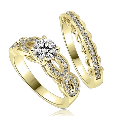 Wedding Set- 1.0 Ct. Round Brilliant Diamond Essence in center with Melee set in intervening design on either side and wedding band with delicately set Melee. 1.35 Cts. T.W. set in 14K Solid Yellow Gold.