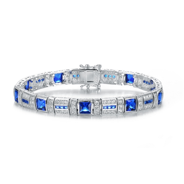 A stunner, this Platinum Plated Sterling Silver 7.25" bracelet features nine princess sapphire stones, 0.25 cts each, joined by melee. 17.0 cts. T.W.