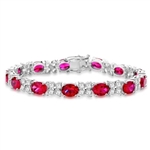 7" long Diamond Essence Designer Bracelet with 1.25 Cts. each Oval cut Ruby Essence and Round Diamond Essence Stones. Appx. 27.0 Cts. T.W. set in Platinum Plated Sterling Silver.