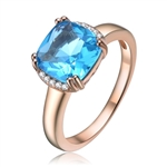 Diamond Essence Designer Ring with 2.5 carat Aquamarine Cushion Essence in 8 prongs setting and delicate melee set on two sides of cushion essence for additional beauty.2.60 Cts.T.W. in Rose Plated Sterling Silver.