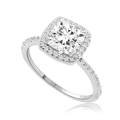 Beautiful Cushion Centerpiece, 1.5 cts, is surrounded by Round Brilliant Melee in this elegant engagement ring. The band consists of round pointer melee to form a brilliant radiance. Appx. 2.5 Ct. T.W. In Platinum Plated Sterling Silver.