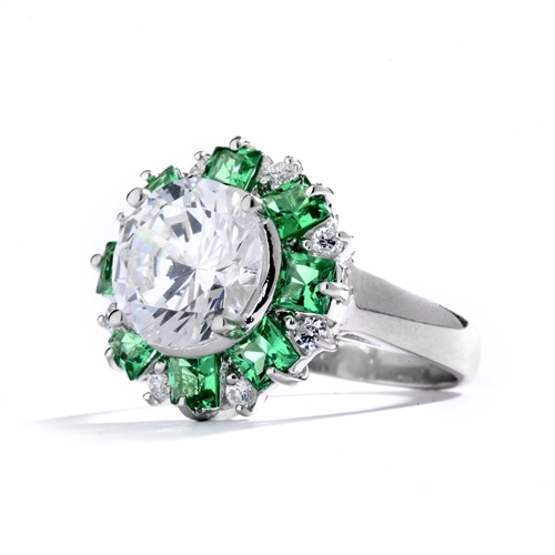 Classic Designer Ring with 3.0 Cts. Round Brilliant Diamond Essence Stone in the center, surrounded by 0.5 Ct. each, Green Princess cut stones and round stones.Round melee set on band, makes it more artistic. 9.50 Cts.T. W.