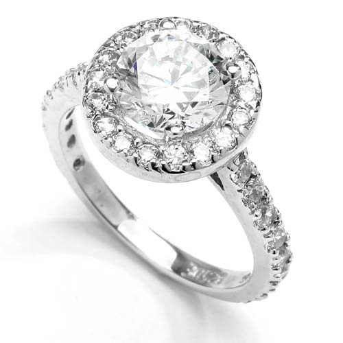 Diamond Essence Halo Setting Designer Ring With 2 Cts. Round Center and Melee around And On The Band, 4.50 Cts.T.W. In Platinum Plated Sterling Silver.