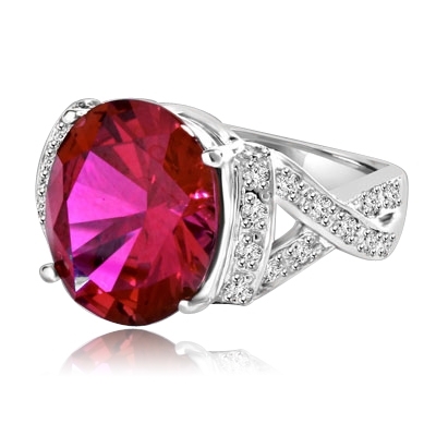 Ruby Ring- 6.0 Cts Oval Cut Ruby Essence in center accompanied by Melee on the band making criss cross design. 6.50 Cts. T.W. set in Platinum Plated Sterling Silver.
