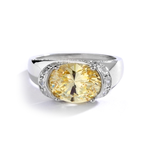 East West Ring- Oval cut Canary Essence set in center with Melee set on side setting going around in criss cross design from center, down the side of the band. 3.25 Cts T.W. set Platinum Plated Sterling Silver.
