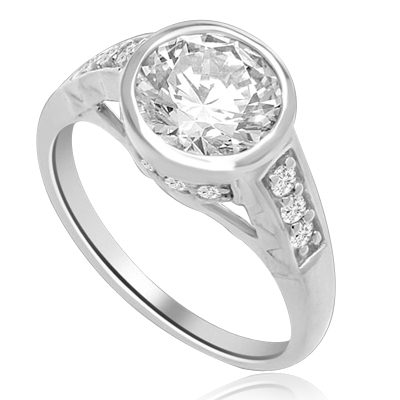 Bezel Set Ring Boasts of 2 Ct Round Solitaire in a unique contemporary band with round accent melee. A sheer beauty! 3 Cts. T.W. In Platinum Plated Sterling Silver.