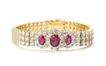 7" long Diamond Essence Bracelet with 2.0 Ct. Ruby in center and 1.0 Ct. Ruby on each side encircled by Diamond Essence stones making 3 rows all around wrist. Appx. 40.0 Cts. T.W. set in 14K Gold Vermeil.