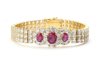 7" long Diamond Essence Bracelet with 2.0 Ct. Ruby in center and 1.0 Ct. Ruby on each side encircled by Diamond Essence stones making 3 rows all around wrist. Appx. 40.0 Cts. T.W. set in 14K Gold Vermeil.