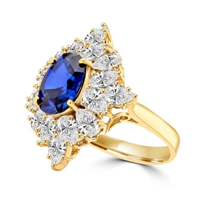 Designer ring with 3.5 Ct. oval Sapphire Essence set in four prongs, and surrounded by pear cut diamond essence stones in floral pattern. 8.5 Cts. T.W. set in 14K Gold Vermeil.