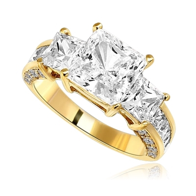 Three Stones Sparkling Ring With Princess Cut Diamond Essence Set in center accompanied by Princess Cut Diamond Essence on each side with channel set Princess stones on band and Melee on side of the band. 3.25 Cts T.W. set in 14 K Gold Vermeil.
