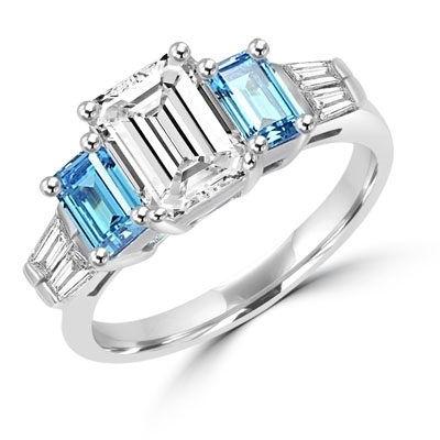 Classic Wide Ring with a 2 Ct. Emerald Cut Brilliant Masterpiece in the center, saluted on each side by a 0.5 ct. Emerald Cut Aquamarine Stone and clear white Baguette Masterpieces further down. 3.5 Cts. T.W, in 14K Solid White Gold.
