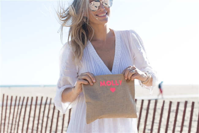 Molly Sims using her personalized neon clutch