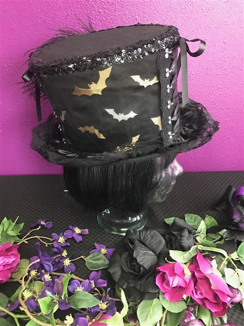 BIG TOP HAT SILVER AND GOLD BATS All Hilary's Vanity Hats are hand made by Hilary shipping can take up to 2 weeks depending of if we have to make a new one or if it is in stock.