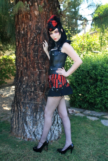 Ruffle Mini Red & Black Skirt - This Straight Short Skirt is done in Striped Heavy Cotton Twill and has a solid black ruffle. Also features Zipper and Button Closures and has one-side Bondage Straps, with matching belt and Side Pockets.