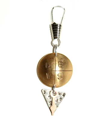 Domed brass disk imprinted with N-E-S-W, silver nickel triangle embellished with brass arrow