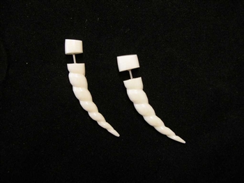 Off white bone is carved in a spiraling horn seashell shape that is curved.