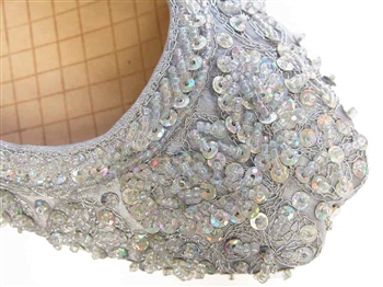 Silver silk Indian khussa shoes are covered with beads and sequins for women.