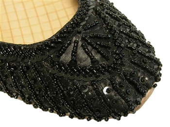 Rich black silk with matching beads and sequins cover these beautiful shoes.