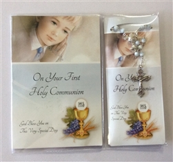 First holy communion booklet and rosary beads