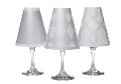 Set of 6 coordinating drum, scroll and solid pattern translucent paper white wine glass shades.  Available in silver and gold.  Made in the USA.