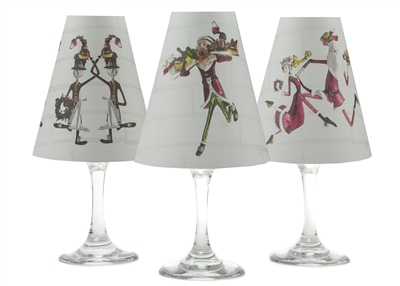 Set of 6 coordinating elf, snowmen, and Mr. and Mrs. Claus pattern translucent paper white wine glass shades by di Potter.  Made in the USA