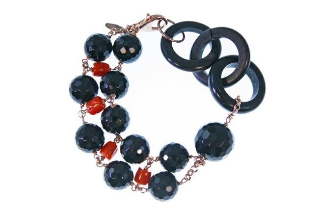 Round faceted Black Onyx Gemstones are accented by Red Coral Nuggets. A single large Onyx bead and three links of natural Black Horn create an asymmetrical look. 925 Rose Gold plated Sterling Silver Chain & Lobster Clasp. 7 1/2" in Length adjustable to 7"