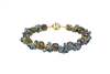 Hand Crafted, this Bracelet features uniquely cut "Cubed" Labradorite Gemstones, alternating with clusters of brilliant, faceted, London Blue Topaz Gemstones. These two Gemstones compliment each other  perfectly. Gold Filled Sterling Chain & Latch.
