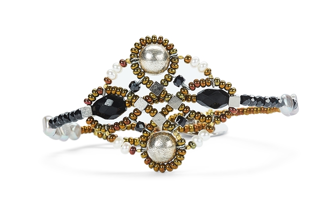 Ziio's small Knott Bracelet with Black Onyx & Tourmaline Gemstones, Mother of Pearl and White Seed Pearls. Also accented with Silver Beads and Murano Glass Seed Beads. 925 Sterling Silver Button Closure, adjustable in length.