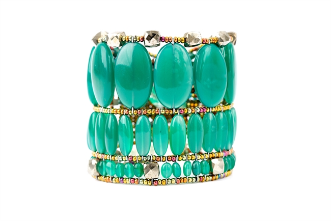 Turn them green with envy with this statement cuff Bracelet by Ziio. Large vibrant Green Onyx Gemstones, oval in shape, create this beautiful piece. Accents of Pyrite Beads add the finishing touch. Hand crafted in Italy. Sterling Silver Button closure