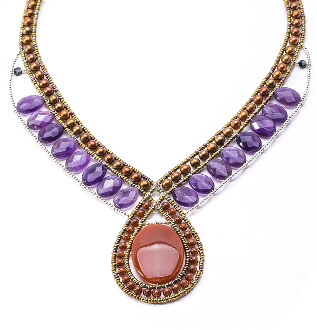 Beaded Pendant has polished Rust/Red Carnelian Gemstone accented with Bronze Pearls & Purple Amethyst Gemstones. The color combination make this piece noticeable and versatile. Hand crafted in Italy. Sterling Button Closure. Adjustable length 18" to 16".