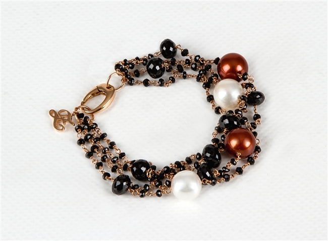 Multi-strand 18k Rose Gold Bracelet by Zoccai. Various sizes of Black Onyx Beads, two White Pearls and two Bronze Pearls add color and style. This is a classic with Italian style. Made in Italy. Lobster Clasp. Pearls are aprox. 11mm