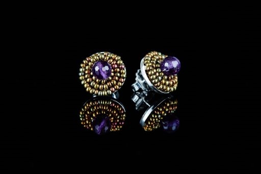 These Button Earrings by Ziio will make a wonderful addition to any wardrobe. A single Purple Amethyst Gemstone is surrounded by two rows of golden Murano Glass Beads. 925 Sterling Silver back & Post. Made in Italy. Dimension 5/8"