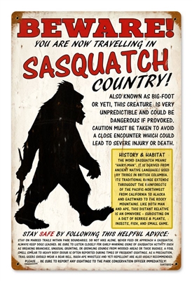 Beware Sasquatch Vintage Metal Sign. This sign reads BEWARE - You are now travelling in Sasquatch Country. Also known as Bigfoot or Yeti, this creature is very unpredictable and could be dangerous if provoked. Measures 12 inches by 18 inches. This Metal S