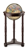 Lancaster Illuminated 12 Inch World Globe. The illuminated Lancaster chair-side floor globe rests on a dark cherry-finish stand with carved accents. Traditional 12 inch antique-ocean globe ball. Metal die-cast meridian.