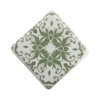 Sage green ceramic cabinet knob with a floral motif.