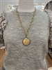 Women's matte gold 24 inch chain with replica gold coin and crystal with a front toggle closure