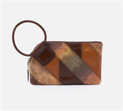 Women's leather clutch handbag in multi mocha patchwork on one side and solid mocha on the back with a circular handle and a top zip.