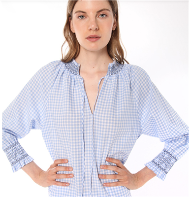 Women's blue and white gingham long sleeve top with navy stitching on the collar and cuffs.