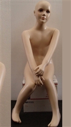 Child Mannequin with Realistic Facial Features in Seated Pose