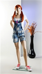Female teenage mannequin with realistic facial features. Her hands are on her hip in a sassy pose.