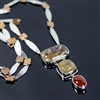 Burning Embers Necklace photo. Silver structure, the string has silver thins in long almond shapes with squares of bronze in between and the pendant has three stones: rectangular and squared rutilated quartz and an oval cornelian. Fiery complection!