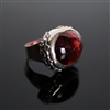 Bittersweet Affair Ring photo. Gorgeous and big red Rubelite is the center of the ring and a silver ring structure holds it with beautiful flowery designs on the sides.