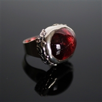 Bittersweet Affair Ring photo. Gorgeous and big red Rubelite is the center of the ring and a silver ring structure holds it with beautiful flowery designs on the sides.