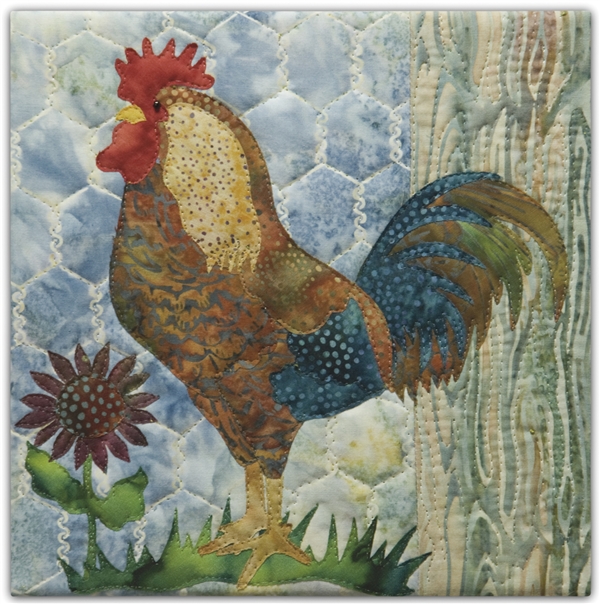 a fabric panel showing the profile of a reddish brown rooster standing on the grass next to a small flower.