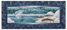 Quilt block of a fisherman catching a rainbow trout that is jumping out of the water, while other trout swim near the river rocks