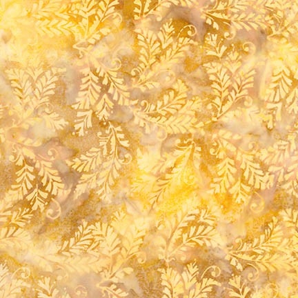 Ornate leaf batik fabric in yellow and gold.