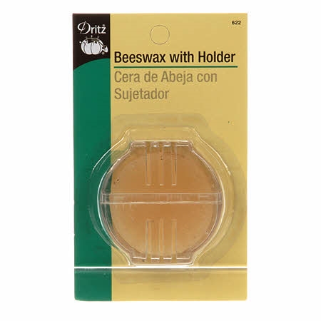 Round of yellow beeswax in slotted plastic case for strengthening thread during sewing, by Dritz